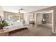 Spacious main bedroom with a king bed and an open door to a secondary bedroom or sitting room at 5905 Paseo Montana, Las Vegas, NV 89108