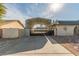 View of the property featuring parking structure with a secure gate and desert landscaping at 5905 Paseo Montana, Las Vegas, NV 89108