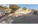 Wide shot shows covered parking structure next to block wall and residential home at 5905 Paseo Montana, Las Vegas, NV 89108