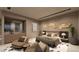 Modern bedroom featuring a king bed, seating area, and wet bar for ultimate comfort at 611 Grand Rim Dr, Henderson, NV 89012