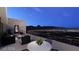 Terrace with a dining area, lounge area with a fire pit, and panoramic city views at 611 Grand Rim Dr, Henderson, NV 89012