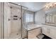 Modern bathroom with a tiled shower, large tub, double vanity, and bright lighting at 6335 Pacific Sky St, North Las Vegas, NV 89081