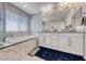 Bright bathroom features a large tub, double vanity, and elegant finishes at 6335 Pacific Sky St, North Las Vegas, NV 89081