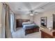 Cozy bedroom features a ceiling fan, a dresser, and a sliding glass door to a balcony at 6335 Pacific Sky St, North Las Vegas, NV 89081