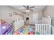 Adorable bedroom features playful decor and a cozy crib, creating a sweet haven for little ones at 6335 Pacific Sky St, North Las Vegas, NV 89081