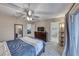 Comfortable bedroom with carpet, ceiling fan, dresser, and connecting bathroom at 6335 Pacific Sky St, North Las Vegas, NV 89081