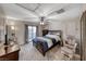 Bedroom with a ceiling fan, balcony access, and neutral decor at 6335 Pacific Sky St, North Las Vegas, NV 89081