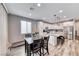Bright dining area adjacent to the kitchen, featuring modern light fixtures and stainless appliances at 6335 Pacific Sky St, North Las Vegas, NV 89081