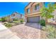 Home featuring a brick paver driveway that leads to a two-car garage, providing ample parking space at 6335 Pacific Sky St, North Las Vegas, NV 89081
