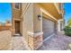 Exterior featuring brick accents, a two-car garage, and a pathway leading to the front door at 6335 Pacific Sky St, North Las Vegas, NV 89081