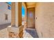 Inviting covered front porch featuring brick pillars and a charming front door for a welcoming entrance at 6335 Pacific Sky St, North Las Vegas, NV 89081