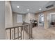 Bright hallway with carpet, gray walls, and a view into another room at 6335 Pacific Sky St, North Las Vegas, NV 89081
