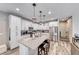 Kitchen has granite countertops, stainless steel appliances, and a large center island with seating at 6335 Pacific Sky St, North Las Vegas, NV 89081