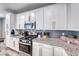 Modern kitchen has granite counters, stainless steel appliances, and white cabinets at 6335 Pacific Sky St, North Las Vegas, NV 89081
