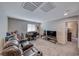 Spacious living room with comfortable seating, desk area, and natural light at 6335 Pacific Sky St, North Las Vegas, NV 89081