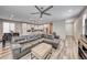 Spacious living room flowing into kitchen with an island, creating a warm and inviting atmosphere at 6335 Pacific Sky St, North Las Vegas, NV 89081