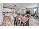Open concept living with dining area that flows into kitchen with white cabinets at 6335 Pacific Sky St, North Las Vegas, NV 89081