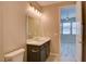 Bathroom with toilet and vanity with dark wood cabinets at 646 Spotted Falcon St, Las Vegas, NV 89138