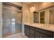 Modern bathroom featuring a double sink vanity, a glass enclosed shower with hexagon tile, and contemporary fixtures at 646 Spotted Falcon St, Las Vegas, NV 89138