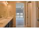 Neutral bathroom features a double sink vanity, with an open doorway that shows the connected bedroom with lots of light at 646 Spotted Falcon St, Las Vegas, NV 89138