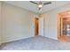 Spacious bedroom with a ceiling fan, neutral walls, and plush carpeting at 646 Spotted Falcon St, Las Vegas, NV 89138