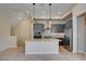 Open-concept kitchen with a large island, stainless steel appliances, and modern finishes at 646 Spotted Falcon St, Las Vegas, NV 89138