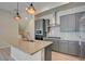 Contemporary kitchen with an island, granite countertops, and stainless steel appliances at 646 Spotted Falcon St, Las Vegas, NV 89138