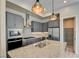 Kitchen with stainless appliances, gray cabinets and a walk-in pantry at 646 Spotted Falcon St, Las Vegas, NV 89138