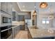 Well-equipped kitchen with gray cabinets, stainless steel appliances, and a spacious island at 646 Spotted Falcon St, Las Vegas, NV 89138