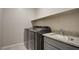 Laundry room with granite countertop and sink, plus modern washer and dryer at 646 Spotted Falcon St, Las Vegas, NV 89138
