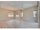 Large living area with wood floors, ceiling fan, and many windows for natural light at 646 Spotted Falcon St, Las Vegas, NV 89138