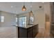Open-concept living space featuring hardwood flooring, modern lighting, and an expansive kitchen island at 646 Spotted Falcon St, Las Vegas, NV 89138