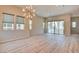 Bright living room with wood floors, modern lighting, and sliding glass doors at 646 Spotted Falcon St, Las Vegas, NV 89138