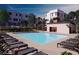 A tranquil community pool is surrounded by lounge chairs and green landscaping, perfect for relaxation and socializing at 646 Spotted Falcon St, Las Vegas, NV 89138