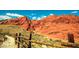 Scenic view of Red Rock Canyon with a rustic wooden fence in the foreground at 646 Spotted Falcon St, Las Vegas, NV 89138