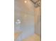 Close up of the modern glass enclosed shower with hexagon tile and a rainfall shower head at 646 Spotted Falcon St, Las Vegas, NV 89138
