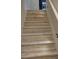 Bright, modern staircase with wood-look treads and ambient lighting at 646 Spotted Falcon St, Las Vegas, NV 89138