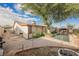 Backyard featuring mature trees, gravel area, and covered gazebo at 6513 Hyde Ave, Las Vegas, NV 89107