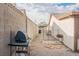 Fenced backyard with gravel, bbq, patio and view of gazebo at 6513 Hyde Ave, Las Vegas, NV 89107