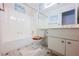 Bright bathroom with white cabinets, tub/shower combo and decorative swan wall art at 6513 Hyde Ave, Las Vegas, NV 89107