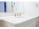 Close-up of a white bathroom sink with a chrome faucet and white countertop at 6513 Hyde Ave, Las Vegas, NV 89107