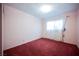 Bedroom with a window and red carpeted floor at 6513 Hyde Ave, Las Vegas, NV 89107