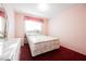 Bedroom with pink walls, red carpet, and a bed at 6513 Hyde Ave, Las Vegas, NV 89107