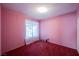 Bedroom with pink walls and red carpet at 6513 Hyde Ave, Las Vegas, NV 89107
