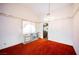 Dining room featuring bright light, textured carpet, white walls with decorative trim, chandelier, and access to kitchen at 6513 Hyde Ave, Las Vegas, NV 89107