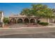 Charming single-story home featuring arched entryways, a well-manicured yard, mature shade tree, and attached two-car garage at 6513 Hyde Ave, Las Vegas, NV 89107