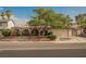 Charming single-story home featuring arched entryways, a well-manicured yard, mature shade tree, and attached two-car garage at 6513 Hyde Ave, Las Vegas, NV 89107