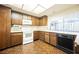 Efficient kitchen with white appliances and wooden cabinetry for a classic look at 6513 Hyde Ave, Las Vegas, NV 89107