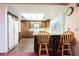 Bright kitchen with ample counter space, breakfast bar, and wood cabinets at 6513 Hyde Ave, Las Vegas, NV 89107