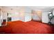 Spacious living room featuring bright light, textured carpet, white walls with decorative trim, and chandelier at 6513 Hyde Ave, Las Vegas, NV 89107